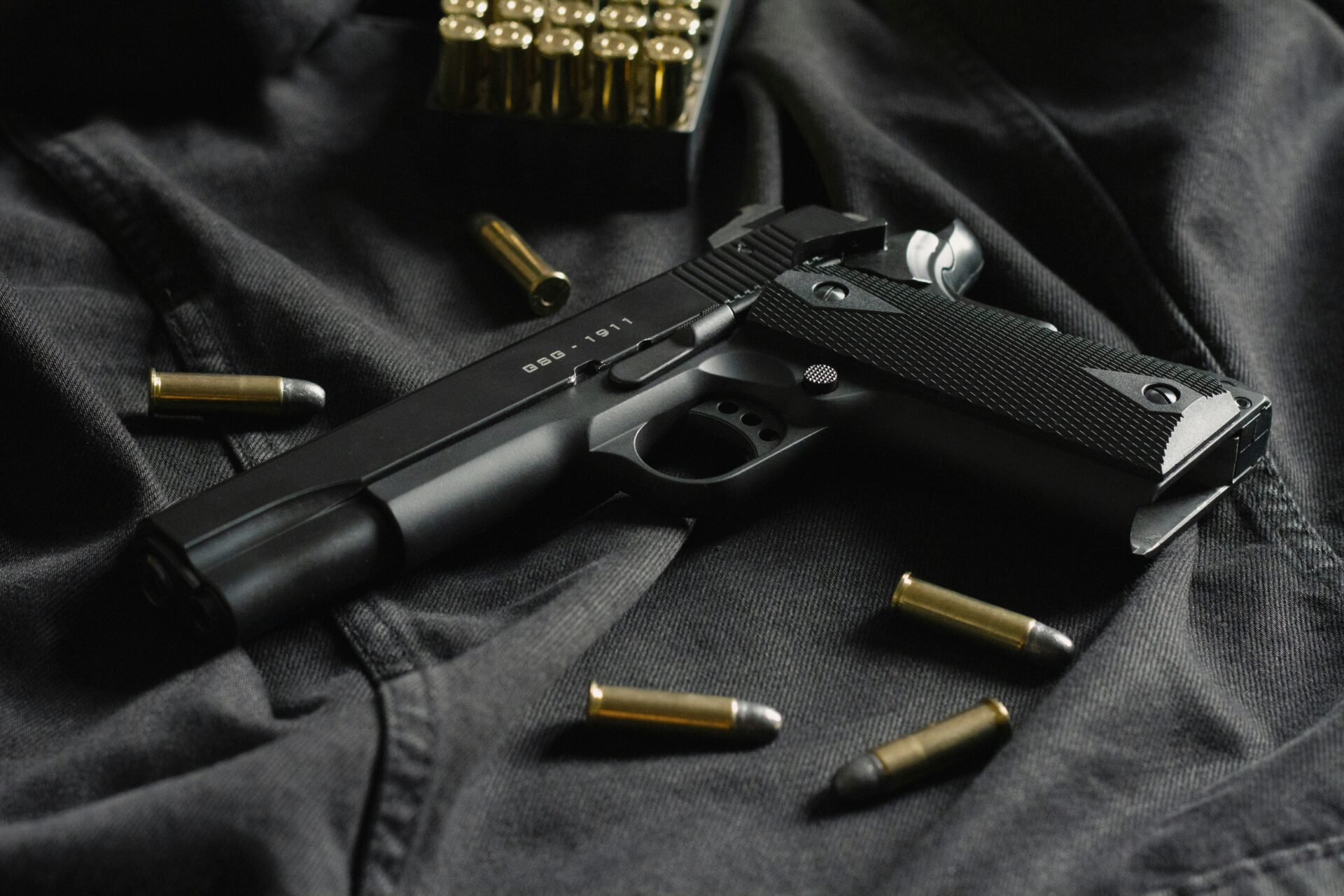 Gun with bullets laying on cloth